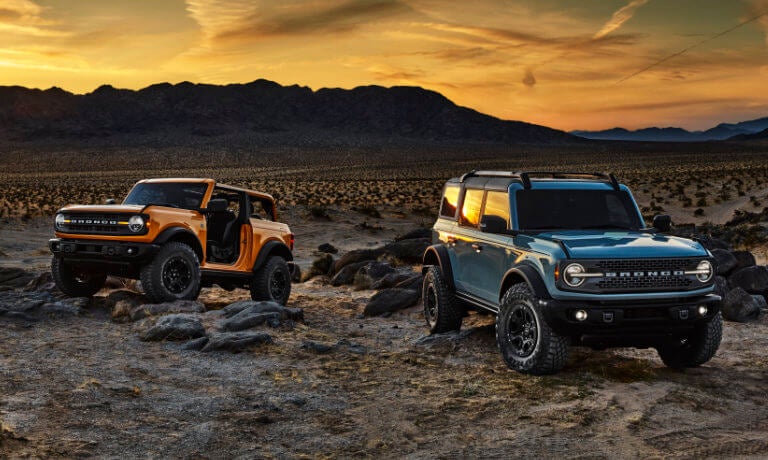 Two 2021 Ford Broncos parked at sunset